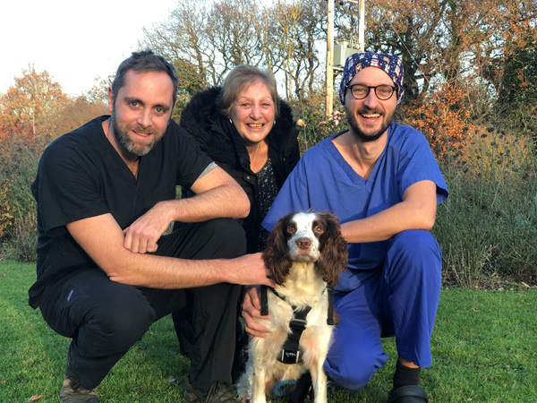 Springer spaniel Star with Cave Veterinary Specialists clinicians Alex Hamilton (left) and Simon Bertram (right), with relieved owner Susan Trigg (centre).
